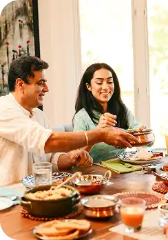 A family sharing a JamunJar vitamin thali